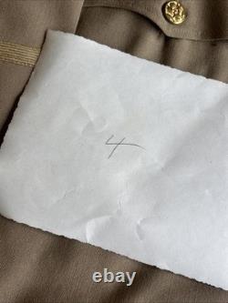 Vintage WWII U. S. Army Air Forces Uniform Jacket with Pins Patches Dog Tags Photo